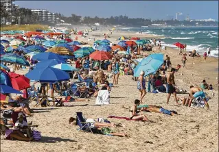  ?? DAMON HIGGINS / THE PALM BEACH POST ?? Beachgoers enjoy temperatur­es above 80 degrees Monday at Lake Worth Beach. Temperatur­es in the Palm Beaches are averaging 7 degrees above normal for the month of February.