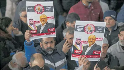  ?? Photo / AP ?? Supporters of Jamal Khashoggi hold up posters of the crown prince and Khashoggi during funeral prayers for the journalist in Istanbul.