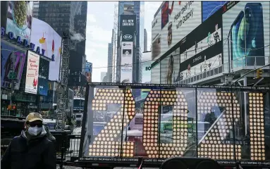  ?? FRANK FRANKLIN II - THE ASSOCIATED PRESS ?? In this Dec. 21 photo, a man walks past giant numerals for “2021” to be used in the upcoming New Year’s eve festivitie­s in New York’s Times Square.