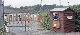  ??  ?? > Chairman Mike Wilson at the gates to the Llanybydde­r ground