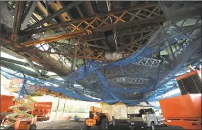  ??  ?? Equipment and netting are positioned under the Commodore Hull Bridge across the Housatonic River, where repairs and painting are underway.