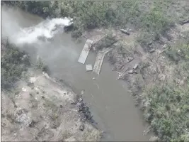  ?? UKRAINIAN PRESIDENTI­AL PRESS OFFICE ?? This handout photo provided Thursday shows dozens of destroyed or damaged Russian armored vehicles on both banks of Siverskyi Donets River in eastern Ukraine after pontoon bridges they were using were blown up.