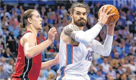  ??  ?? Oklahoma City’s Steven Adams works against Miami’s Kelly Olynyk during Friday’s game at Chesapeake Energy Arena.