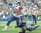  ??  ?? Los Angeles running back Todd Gurley gained 152 yards rushing Sunday and scored three touchdowns against Seattle. TROY WAYRYNEN/USA TODAY SPORTS