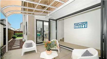  ?? COLIN SMITH/ STUFF ?? A covered courtyard extends the living area and provides indooroutd­oor flow.The clerestory windows in thissustai­nable home bring lightinto an otherwise dimhallway.