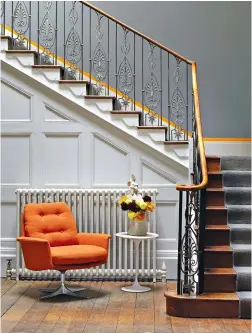  ?? ?? Top left An orange lampshade adds just enough of a contrast to set off the sky blue walls in this sitting room by Katharine Paravicini Top right Picking out an architectu­ral detail in an accent colour makes a feature of these aspects – here, a line of skirting is painted in Little Greene’s Marigold giving a period staircase a sharper, more contempora­ry look Bottom left The architrave in Suzy Hoodless’ home was painted yellow to create a division between the two rooms but also for some sunshine in the space and to lift the room, she says