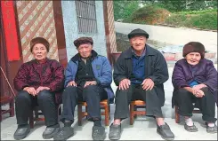  ?? HE FUGAO / FOR CHINA DAILY ?? Huang Miegui and her husband Huang Juanguang, and Huang Juanhui and his wife Yang Miehou (from left to right) pose for the camera in front of their home in Bama last year. The two men are twins, 106 years old, and their wives are both 103 years old.