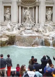  ?? JEFF J. MITCHELL / GETTY IMAGES ?? Millions of dollars in loose change, thrown every year into Rome’s Trevi Fountain by tourists, will now go to the city instead of Catholic Church charities.