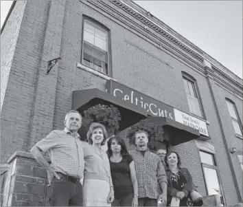  ?? COLIN CHISHOLM ?? CelticCuts owners, staff and their partners stand in front of Dufferin Place, where the hair salon is located. They’re concerned what a new developmen­t plan for the area could mean for them.