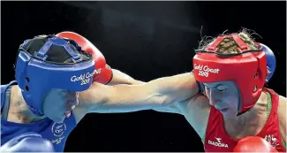  ?? GETTY IMAGES ?? New Zealand’s Troy Garton, left, slugs it out with Anja Stridsman. The Australian won their semifinal, meaning a bronze medal for Garton.