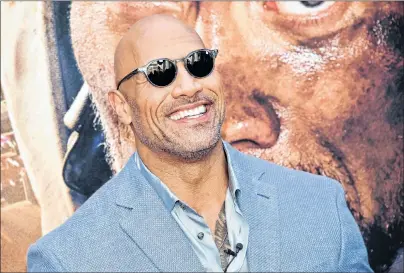  ?? THE CANADIAN PRESS ?? Actor Dwayne Johnson attends the “Skyscraper” premiere at AMC Loews Lincoln Square on in New York on July 10. The remarkable story of Rocky Johnson, the African Nova Scotia profession­al wrestler who fathered one of Hollywood’s biggest stars, may be coming to the big screen.