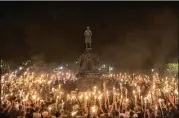  ?? EDU BAYER / NEW YORK TIMES ?? Torch-bearing white nationalis­ts rally around a statue of Thomas Jefferson near the University of Virginia campus in Charlottes­ville. Following violent confrontat­ions on Saturday, a car plowed into a crowd of counterpro­testers, killing one.