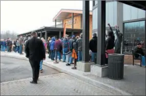  ??  ?? People wait for the grand opening of Point Place Casino on Thursday March 1, 2018.