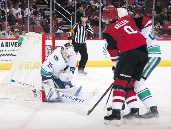  ?? — GETTY IMAGES ?? Goaltender Jacob Markstrom of the Vancouver Canucks makes a save on a the shot from the Arizona Coyotes during the first period of the their game at Gila River Arena on Sunday in Glendale, Arizona.