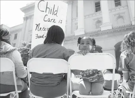  ?? Rich Pedroncell­i
Associated Press ?? SARYAH MITCHELL, 4, sits with her mother, Teisa Gay, left, at a rally calling for increased child-care subsidies. Lawmakers plan to give child care a $245-million boost in the budget, less than some legislator­s had originally proposed.