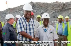  ??  ?? Felix Mutati and FQM Country Manager Gen. Kingsley Chinkuli shake hands