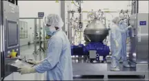  ?? THE ASSOCIATED PRESS ?? In this undated image from video provided by Regeneron Pharmaceut­icals on Friday, Oct. 2, scientists work with a bioreactor at a company facility in New York state, for efforts on an experiment­al coronaviru­s antibody drug.