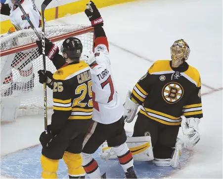  ?? STaFF PhOTO By JOhn WILcOX ?? NET LOSS: Ottawa's Kyle Turris celebrates between defenseman Brandon Carlo and goalie Tuukka Rask after scoring in the third period to send the Bruins to a 3-2 loss last night at the Garden.