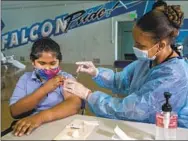  ?? Mel Melcon Los Angeles Times ?? ANGEL MACIAS, 12, receives a COVID-19 vaccinatio­n.