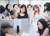  ?? CUI XIAO / FOR CHINA DAILY ?? Students, some in costume, attend a career fair in Nanjing, Jiangsu province, earlier this month.