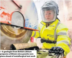  ??  ?? A geologist from British Lithium prepares a lithium mica granite core piece ahead of metallurgi­cal test work