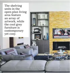  ??  ?? The shelving units in the open-plan living area feature an array of artwork, while the cool grey furniture is contempora­ry yet cosy.