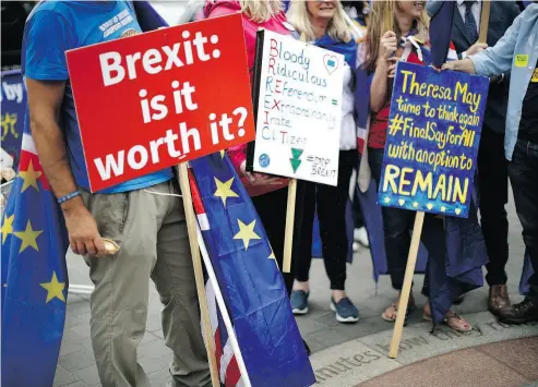  ?? MATT DUNHAM / THE ASSOCIATED PRESS ?? Anti-Brexit supporters hold placards during a protest near the Houses of Parliament in London earlier this year. The divisions opened up by the 2016 referendum have hardened, splitting Britain into two camps: leavers and remainers.