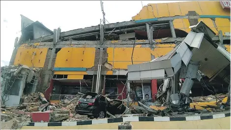  ?? GETTY IMAGES ?? A building in Palu lies in ruins after an earthquake and tsunami hit the city on Indonesia’s Sulawesi island.