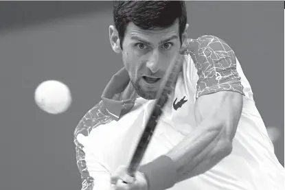  ?? AP ?? CRUISIN'. Novak Djokovic of Serbia hits a return shot to Marco Cecchinato of Italy during their men's singles match of the Shanghai Masters tennis tournament at Qizhong Forest Sports City Tennis Center in Shanghai, China, Thursday, Oct. 11, 2018.