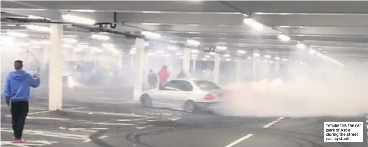  ??  ?? Smoke fills the car park of Asda during the street racing stunt