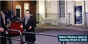  ?? ?? Robert filming a piece in Downing Street in 2016