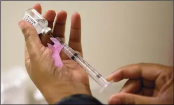  ?? Associated Press ?? In this Feb. 7, 2018 file photo, a nurse prepares a flu shot at the Salvation Army in Atlanta.