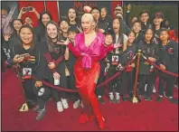  ?? (AP/Chris Pizzello) ?? Singer Christina Aguilera poses with students from the Wushu Action Star Academy martial arts school in Temple City, Calif., at the premiere of the film “Mulan” at the El Capitan Theatre on March 9, 2020, in Los Angeles.
