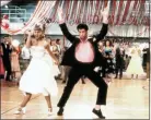  ??  ?? Olivia Newton John and John Travolta in a scene from the 1978film “Grease.”