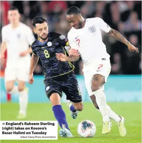  ?? Adam Davy/Press Associatio­n ?? > England’s Raheem Sterling (right) takes on Kosovo’s Besar Halimi on Tuesday