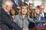  ?? J. SCOTT APPLEWHITE / ASSOCIATED PRESS ?? Ex-U.S. Rep. Gabby Giffords of Arizona, who survived a 2011 assassinat­ion attempt, joins Reps. Mike Thompson, D-Calif. (left), John Lewis, D-Ga., and other House Democrats in a call for action on gun safety legislatio­n on Wednesday at the Capitol in...