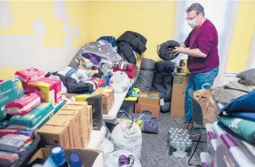  ?? MARKMIRKO/HARTFORD COURANT ?? Bryan Flint, deputy director of Cornerston­e, sorts sleeping bags inside the Manchester Overnight Winter Warming Center at The Community Y. The center operates from 6 p.m. to 9 a.m. seven days a week.