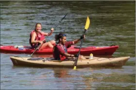  ?? PHOTO BY MICHILEA PATTERSON – FOR MEDIANEWS GROUP ?? People kayak along the Schuylkill River during an annual sojourn organized by the Schuylkill Greenways National Heritage Area. Schuylkill River Greenways is partnering with MCCC and the Green Valleys Watershed Associatio­n to offer a summer camp for middle school girls. One of the activities will be kayaking.