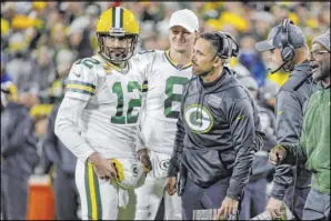  ?? Mike Roemer The Associated Press ?? Quarterbac­k Aaron Rodgers (12), shown with firstyear coach Matt LaFleur during a win over the Lions on Monday in Green Bay, Wis., has led the Packers to a 5-1 record and first place in the NFC North.