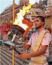  ?? — PTI ?? A Hindu priest performs aarti on the occasion of Ganga Dussehra in Varanasi on Monday, during Covid-19 lockdown 5.0.