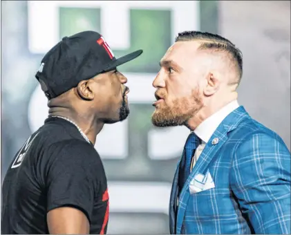  ?? AP PHOTO ?? Floyd Mayweather, left, and Conor Mcgregor exchange harsh words during a promotiona­l tour stop in Toronto on Wednesday for their upcoming boxing match in Las Vegas.