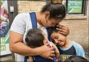  ?? RICHARD DREW / ASSOCIATED PRESS ?? Eilyn Carbajal reunites with her children in August at the Cayuga Center in New York. Immigrant families are facing tougher rules to take custody of children and relatives who crossed the U.S. border.
