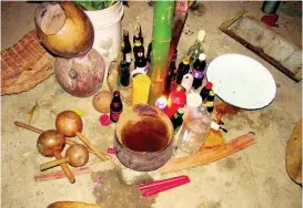  ??  ?? A bottle of rum or two are a staple at the altar of indigenous rituals in Jamaica.