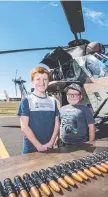  ??  ?? Kyle (left) and Levi McEwen check out the ammunition of an ARH Tiger.