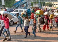  ?? PTI ?? Migrant workers from Uttar Pradesh and Bihar leave for their homes in view of some protests which broke out over the alleged rape of a 14-month-old girl in Ahmedabad on Monday. —