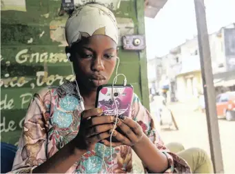  ?? EPA ?? A WOMAN uses a cellphone in Abidjan, Ivory Coast. Mobile network operators have stiff competitio­n for the millions of African consumers looking to connect, but there is a growing trend among government­s on the continent to shut down internet and broadcasti­ng services to stifle dissent. | African News Agency (ANA)