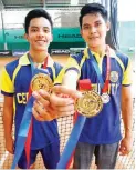  ??  ?? Norman Joseph Enriquez of Cebu City, left, who won three gold medals in tennis (singles, doubles, and mixed doubles), shows off his doubles gold alongside his brother Mark in the Philippine National Games yesterday at the Citi Green Tennis Club in Cebu...