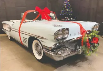  ??  ?? The freshly restored 1958 Pontiac Parisienne convertibl­e came wrapped in ribbon for Christmas.