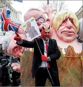  ?? AP/KIRSTY WIGGLESWOR­TH ?? Protesters display effigies of British politician­s, including Conservati­ve leaders Michael Gove and Boris Johnson, during a march Saturday in London.