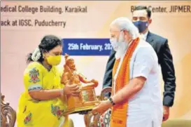  ?? PTI ?? PM Narendra Modi being presented a memento by new lieutenant governor Tamilisai Soundarara­jan, in Puducherry on Thursday.